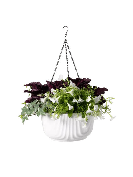 a white hanging planter with green and purple flowers