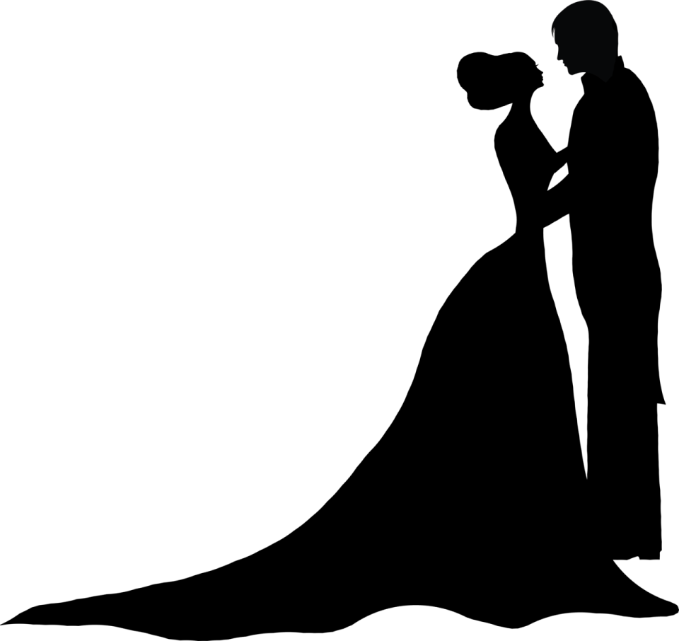 a silhouette of a bride and groom kissing