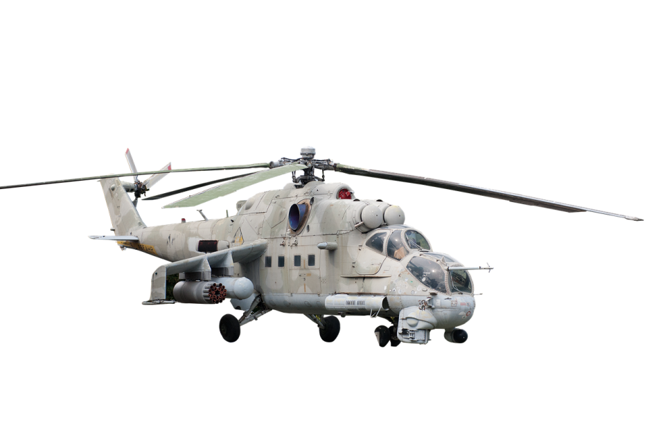 a military helicopter flying in the sky