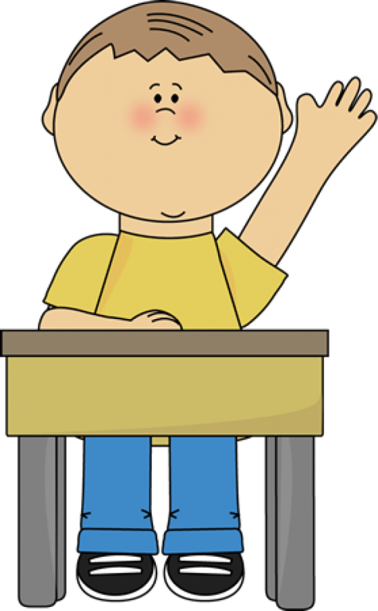 a boy sitting at a desk with his hand up