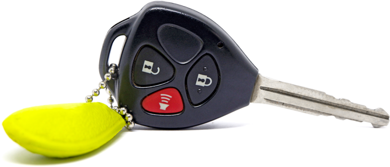 a car key with a yellow ball attached to it