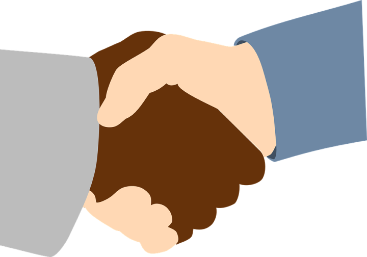 two hands shaking over each other hands