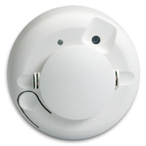 a white smoke detector with the light on it