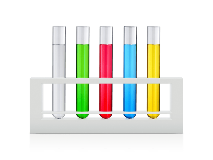 three test tubes with colorful liquids on white background