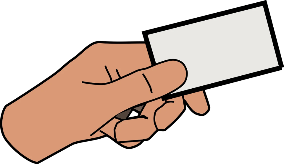 a hand holding a business card