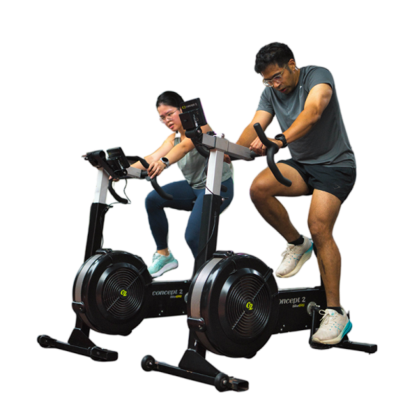 a man and woman on an exercise bike