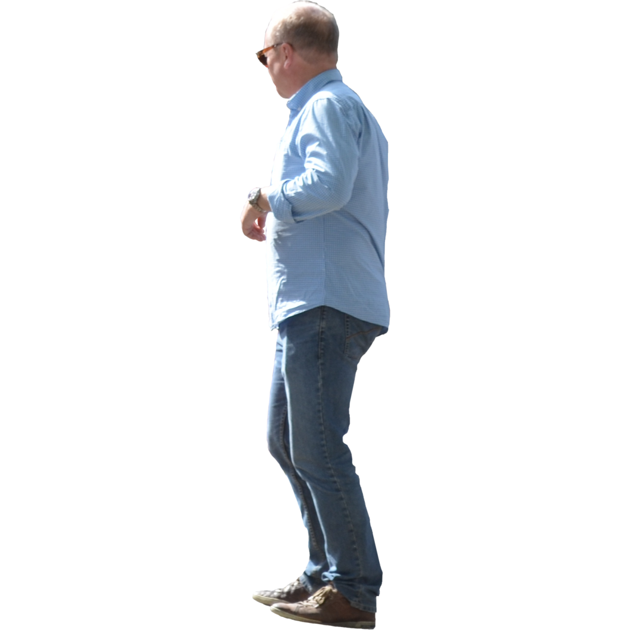 a man in a blue shirt and jeans is walking