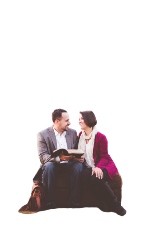 a man and woman sitting on top of a couch