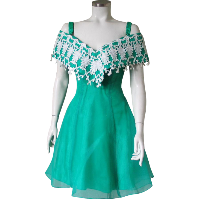 a green dress with white lace on the shoulders
