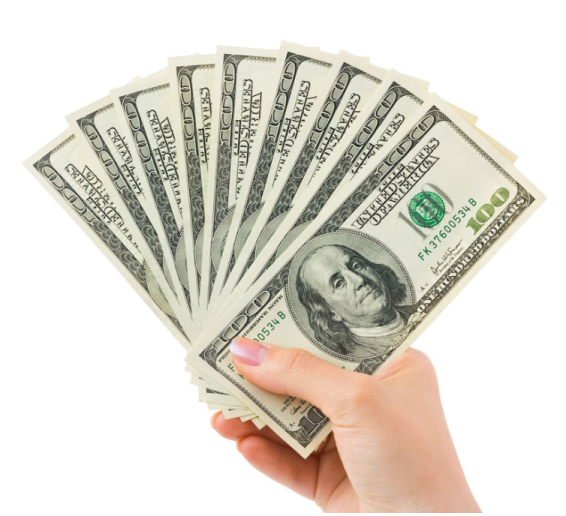 a person holding money in their hand