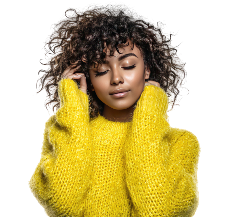 a woman with curly hair wearing a yellow sweater