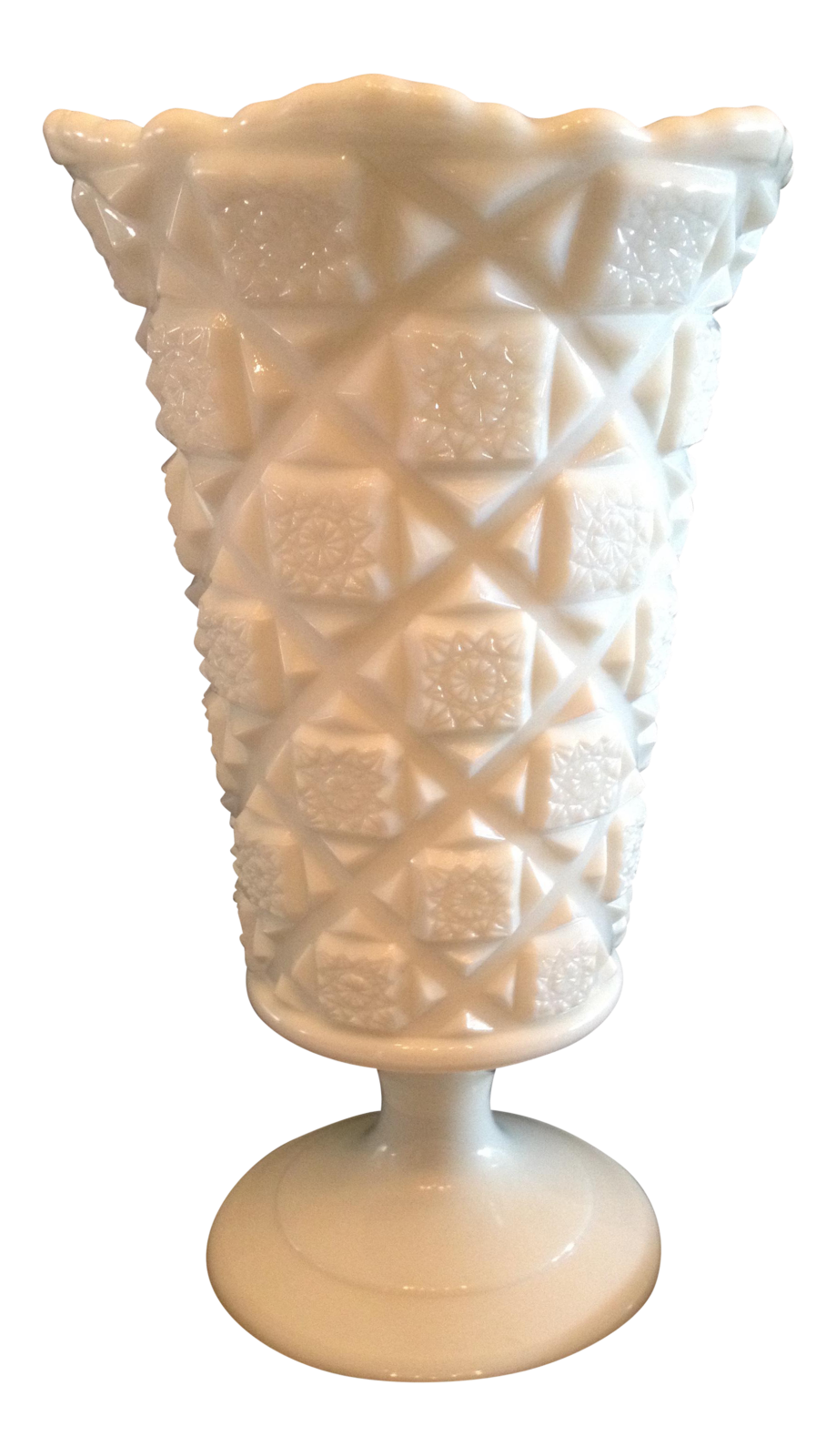 a white vase sitting on top of a table