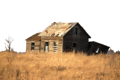 an old house in the middle of a field