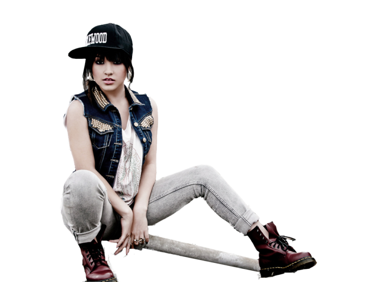 a woman sitting on the ground wearing a hat