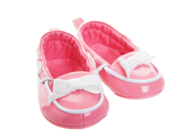 a pair of pink baby shoes with white bows
