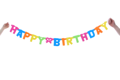 a person holding up a happy birthday banner