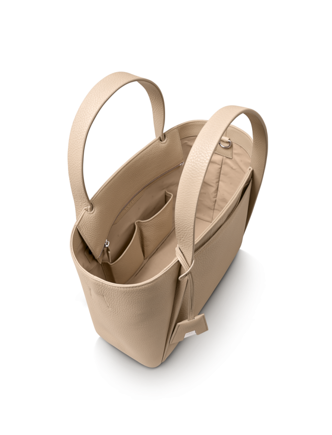 a beige leather tote bag on a white background