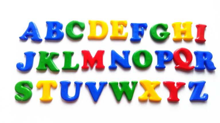 a set of colorful plastic letters on white background