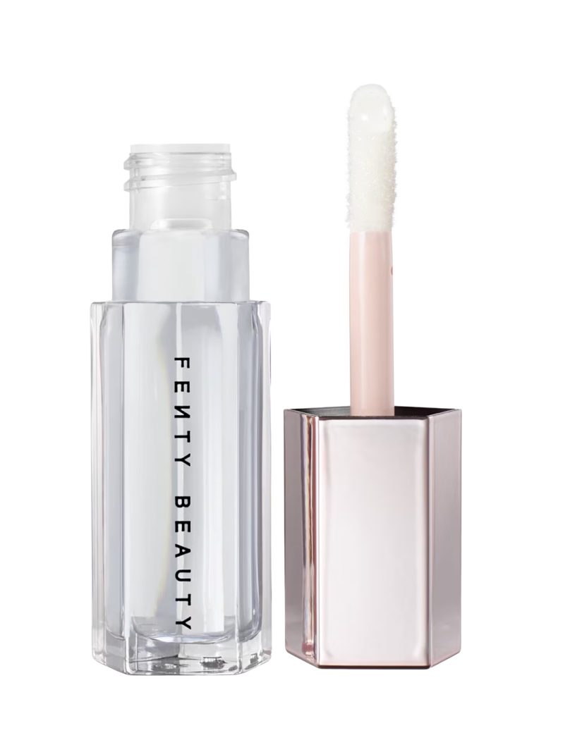 a white bottle of makeup next to a clear tube