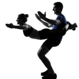a silhouette of a man and woman doing a kick
