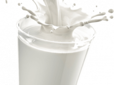 a glass filled with milk and splashing