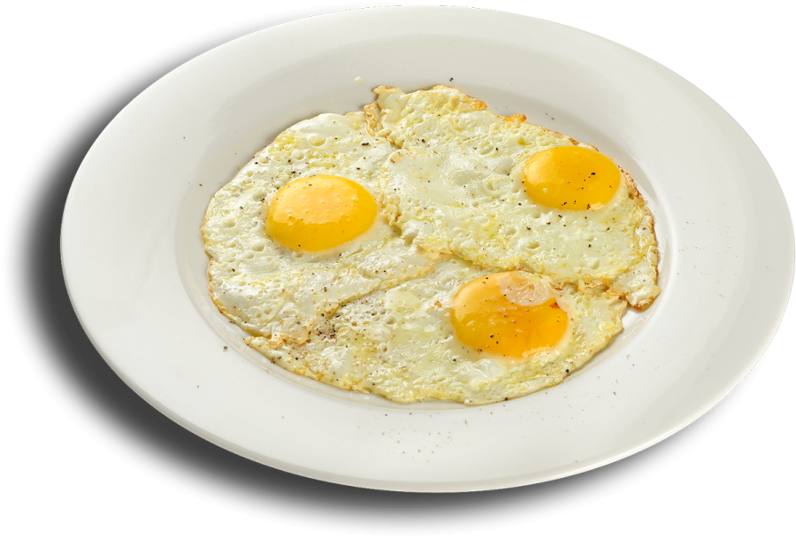 a white plate with two fried eggs on it
