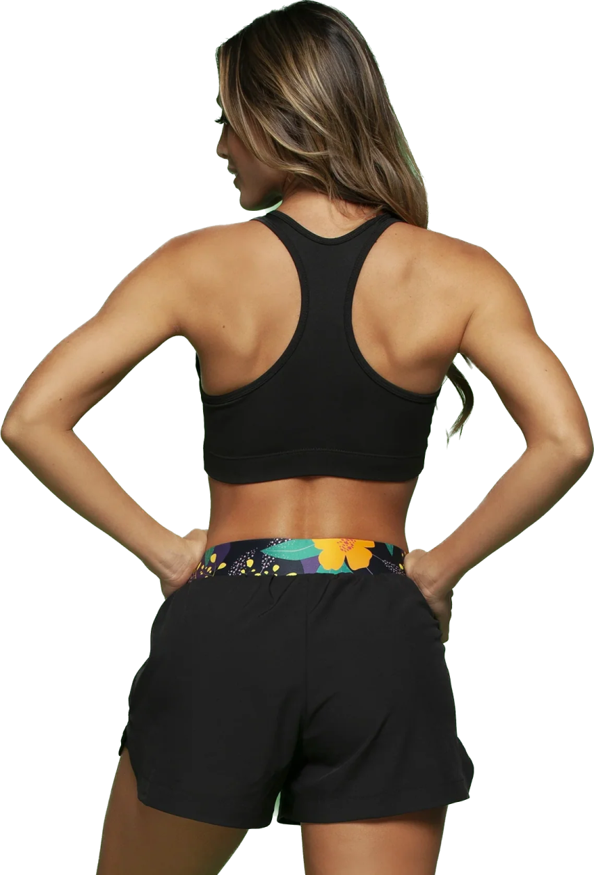 a woman wearing a black sports bra top and shorts