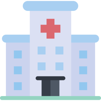 a hospital building with a red cross on top