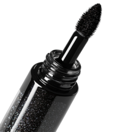 a mascara with black glitter on it