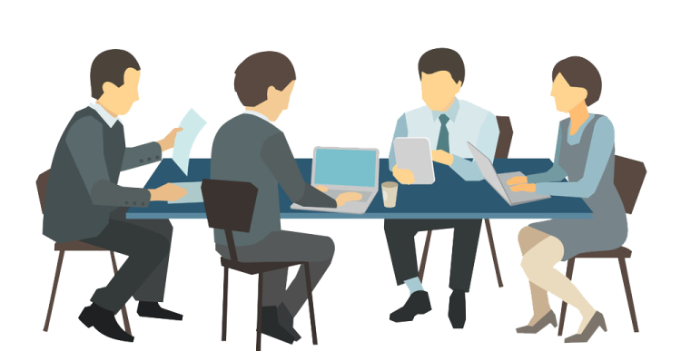 a group of people sitting at a table with laptops