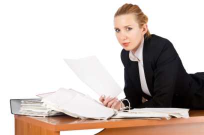 a woman sitting at a desk with papers
