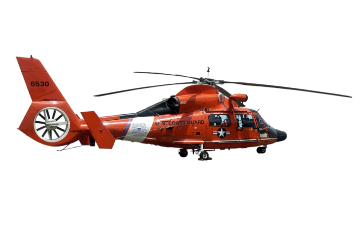 a red helicopter flying through the air