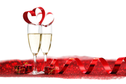 a glass of champagne with a red ribbon around it