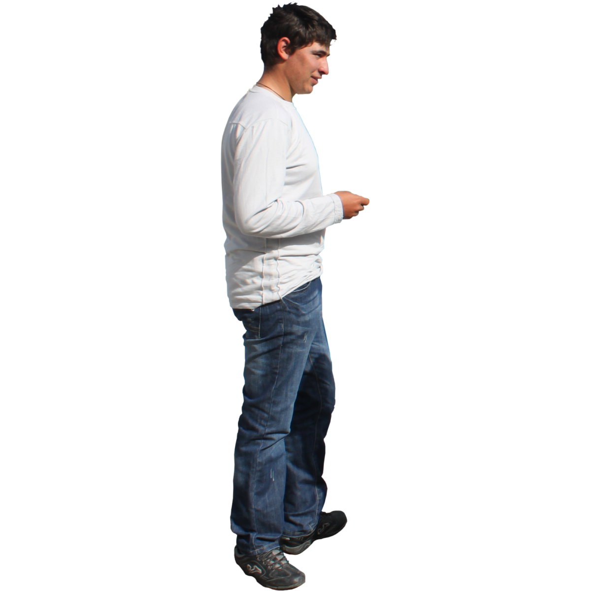 a man in a white shirt and blue jeans looking at his cell