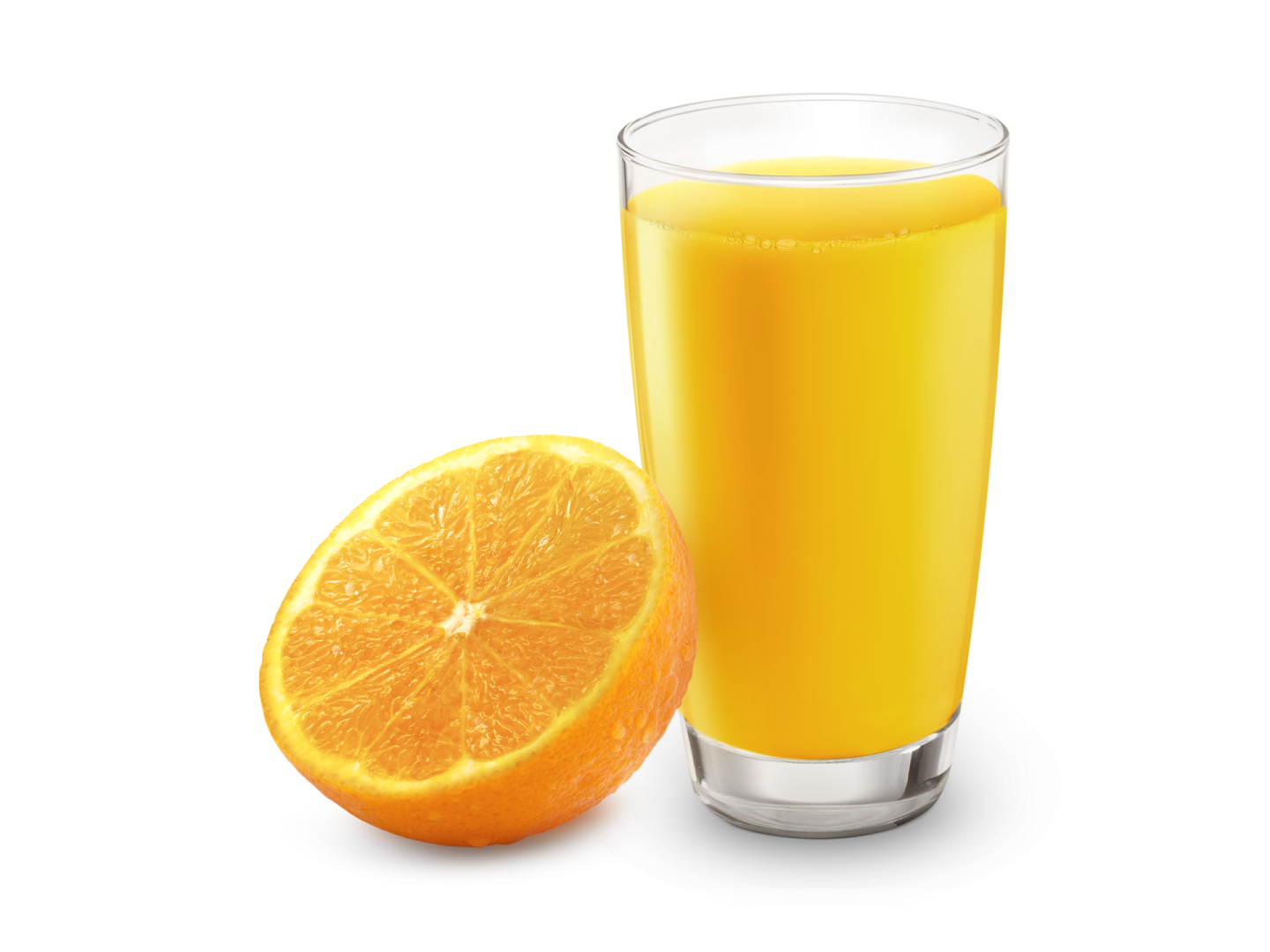 a glass of orange juice next to an orange