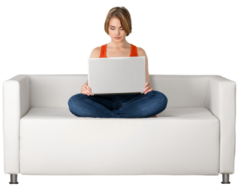a woman sitting on a couch using a laptop