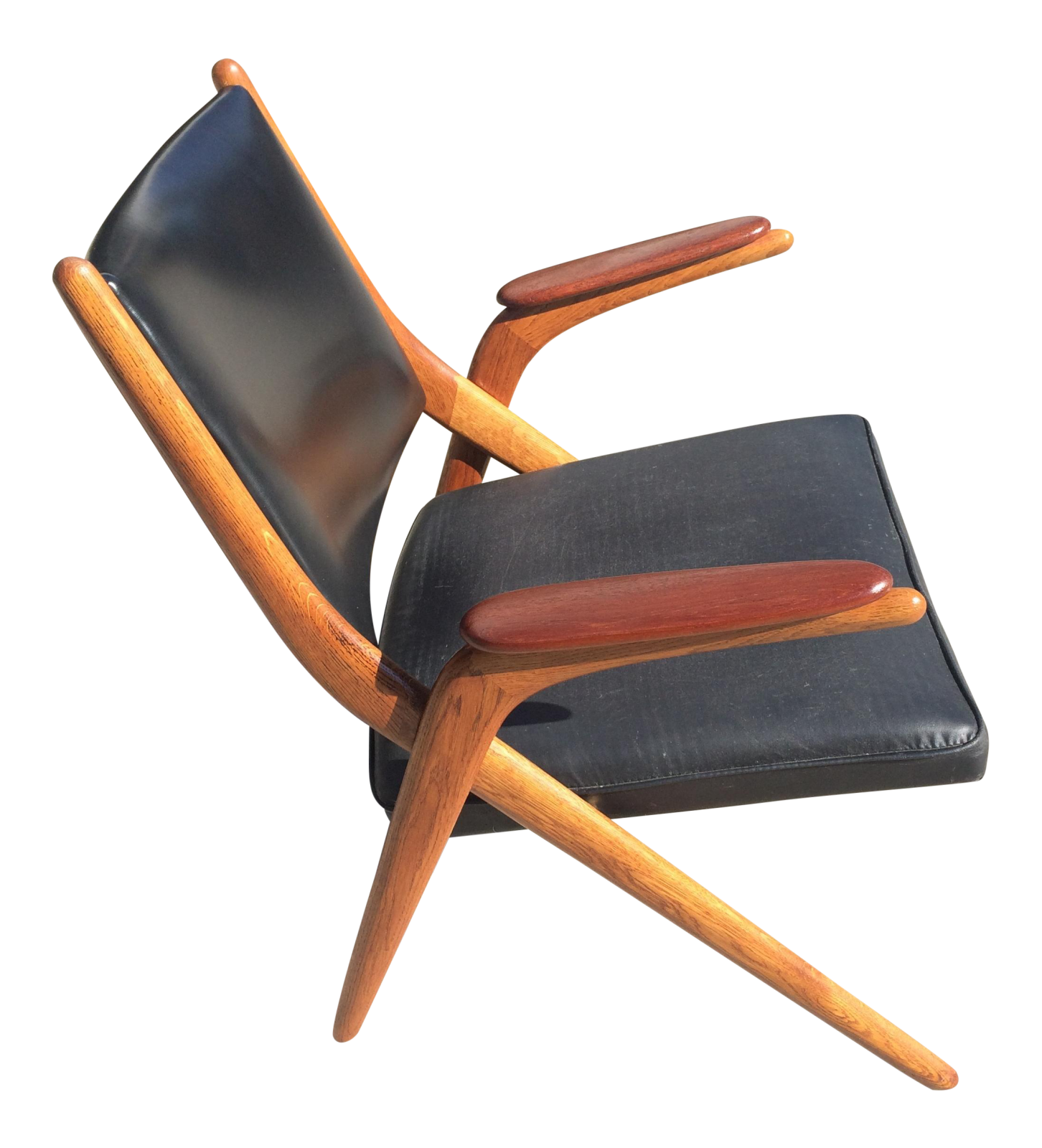 a black leather and wood lounge chair