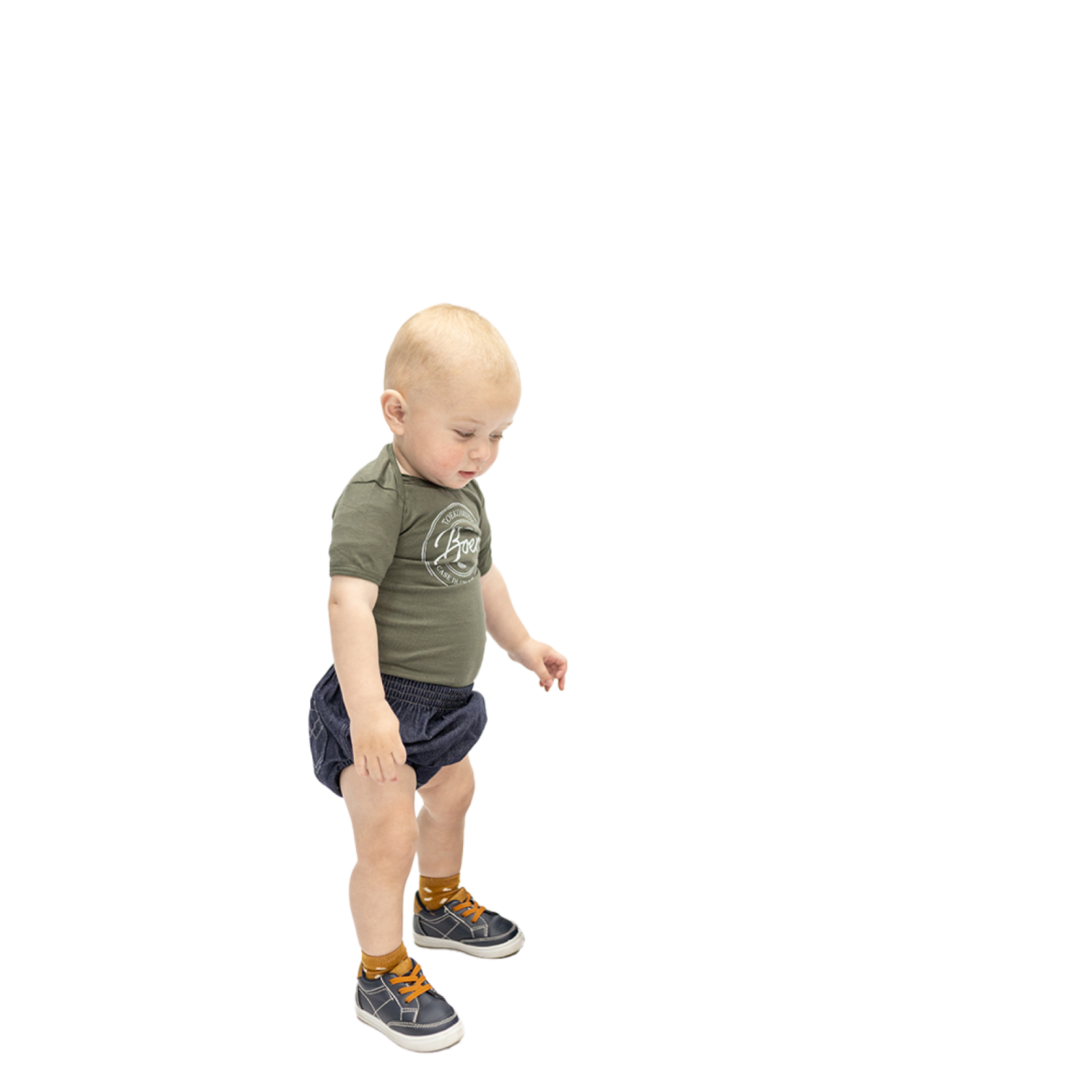 a small child in a green shirt and blue shorts
