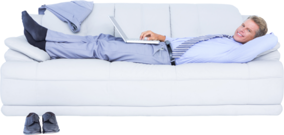 a man laying on a couch with his laptop