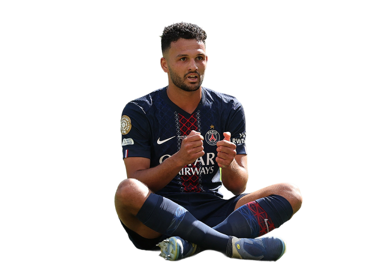 a man sitting on the ground holding a soccer ball