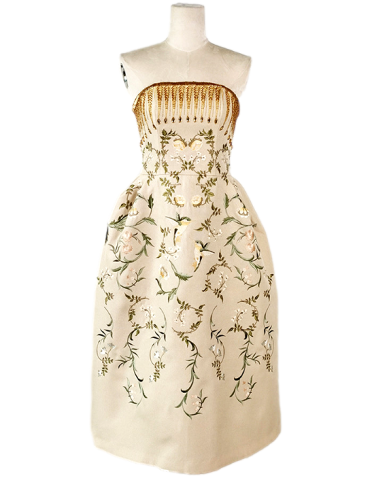 a white dress with floral embroidery on it