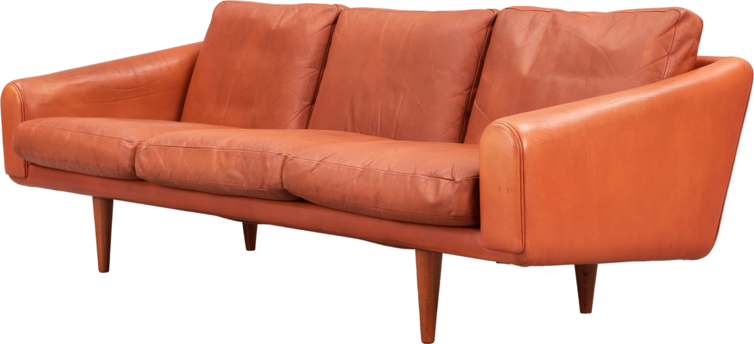 an orange leather sofa with wooden legs