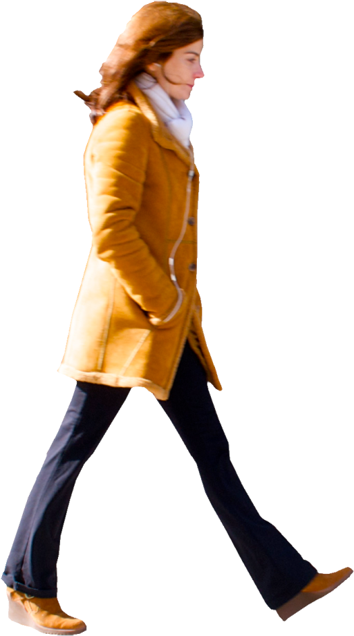 a woman in a yellow coat is walking