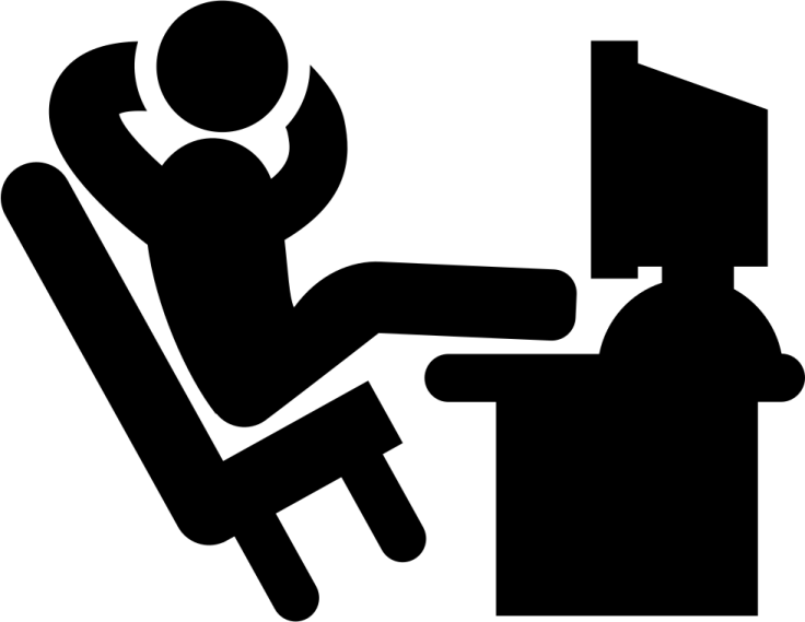 a black and white silhouette of a person sitting at a desk