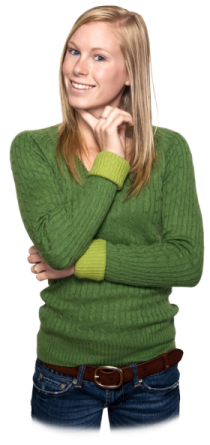 a woman wearing a green sweater and jeans