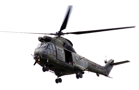 a military helicopter flying through the air