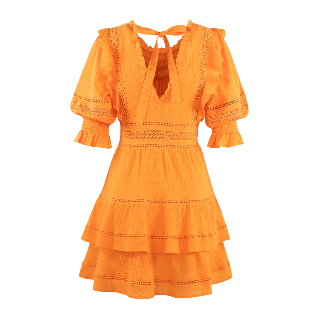 a woman wearing an orange dress with lace detailing