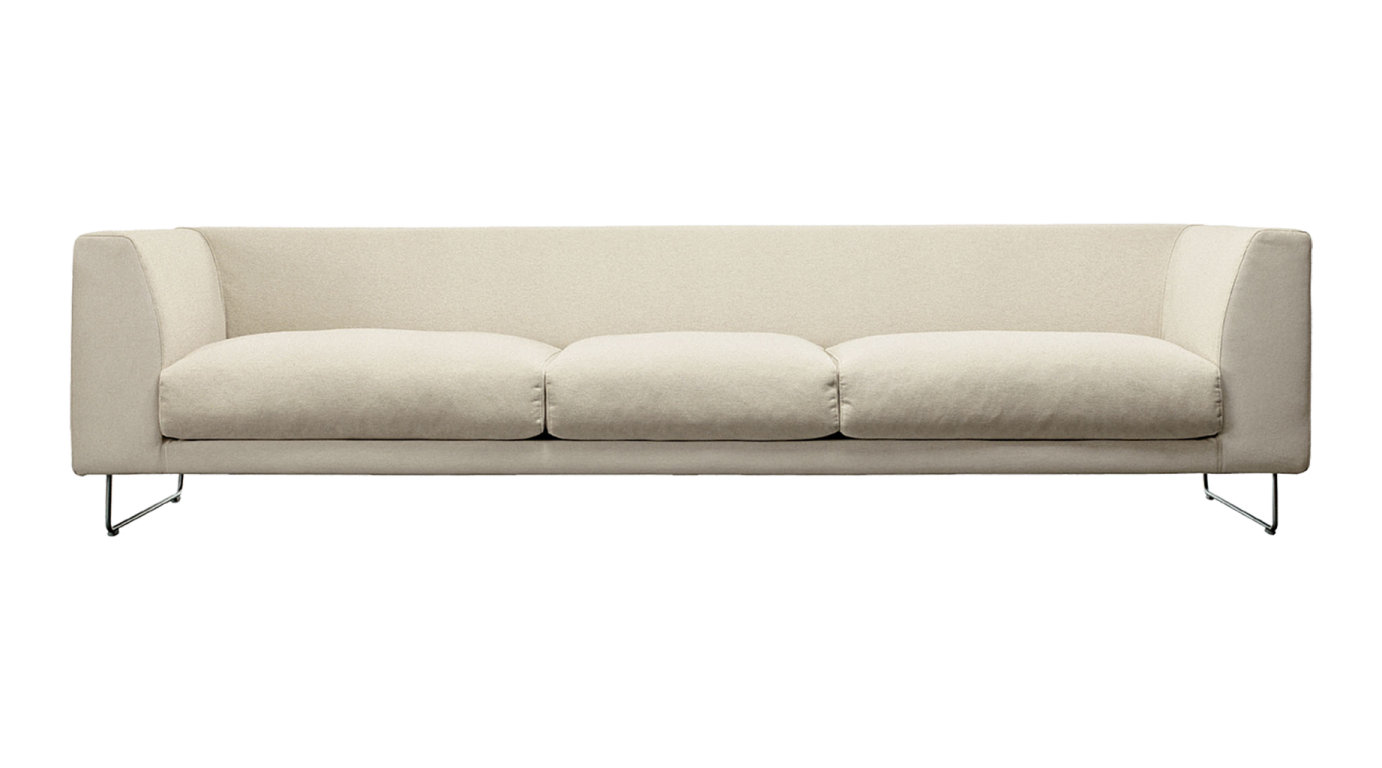 a white couch with two pillows on it