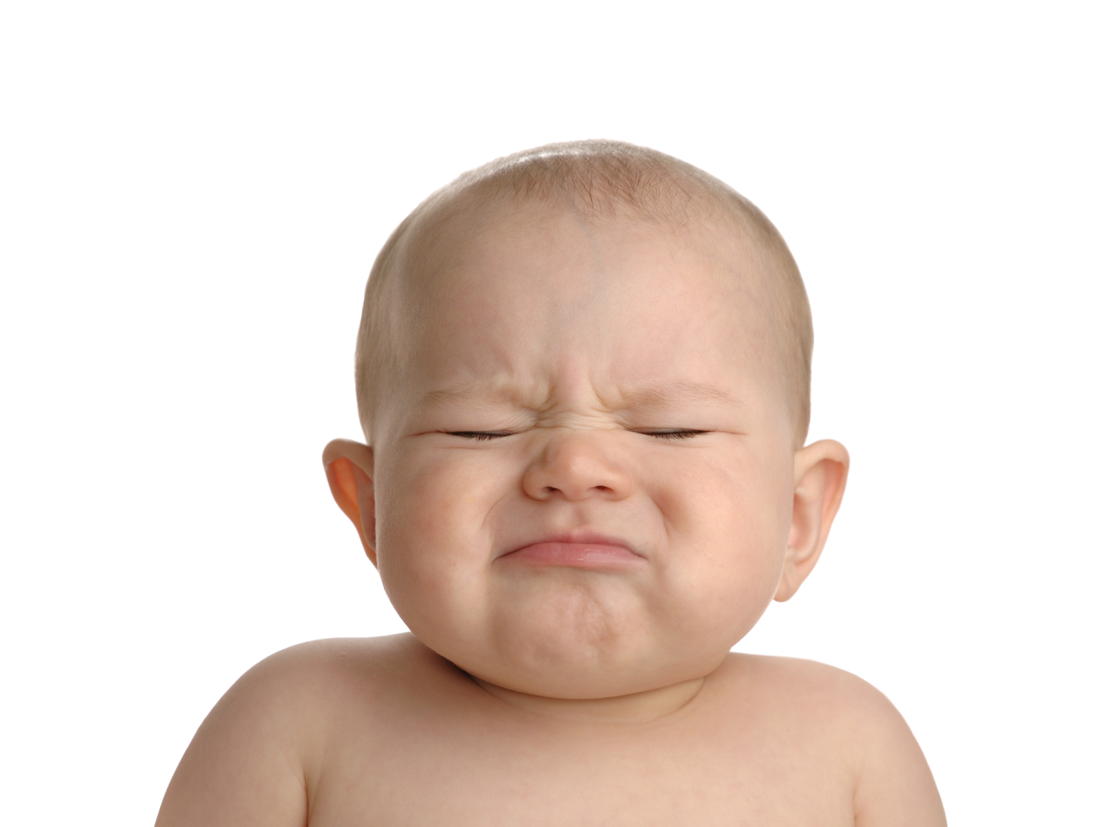 a baby crying with his eyes closed