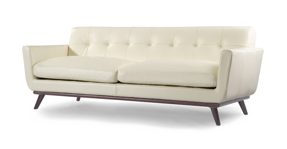 a white leather sofa with wooden legs and arms